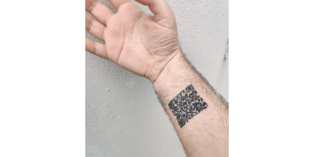 A QR Code tattoo on the forearm.