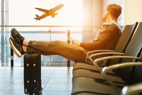 Mumbai airport stop stamping boarding passes: man sitting at airport