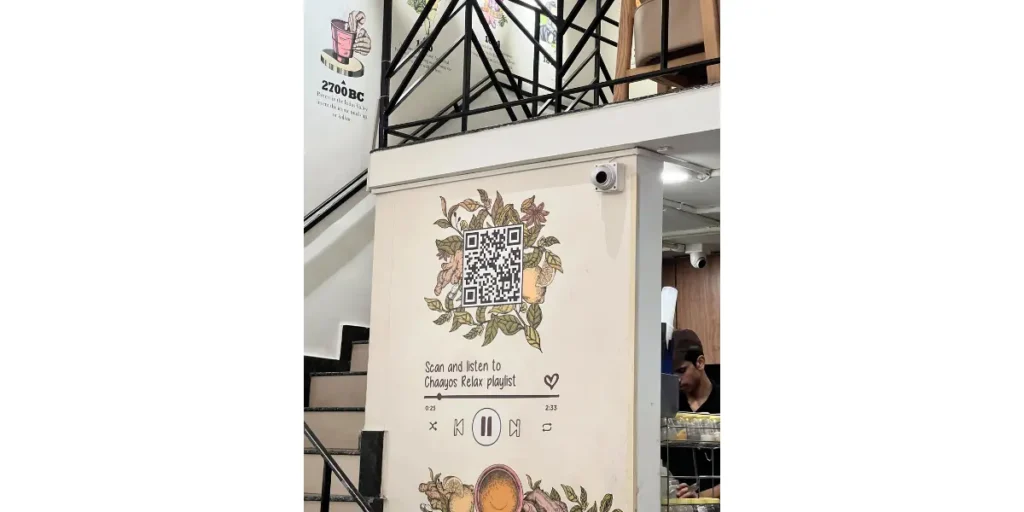 Chaayos using a beautiful QR code mural with a flower background in its cafe, allowing customers to access a relaxing Spotify playlist.