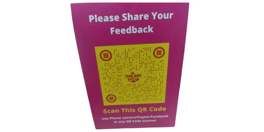 Kailash Dhaba using a pink and yellow table tent with a QR code to gather customer feedback.