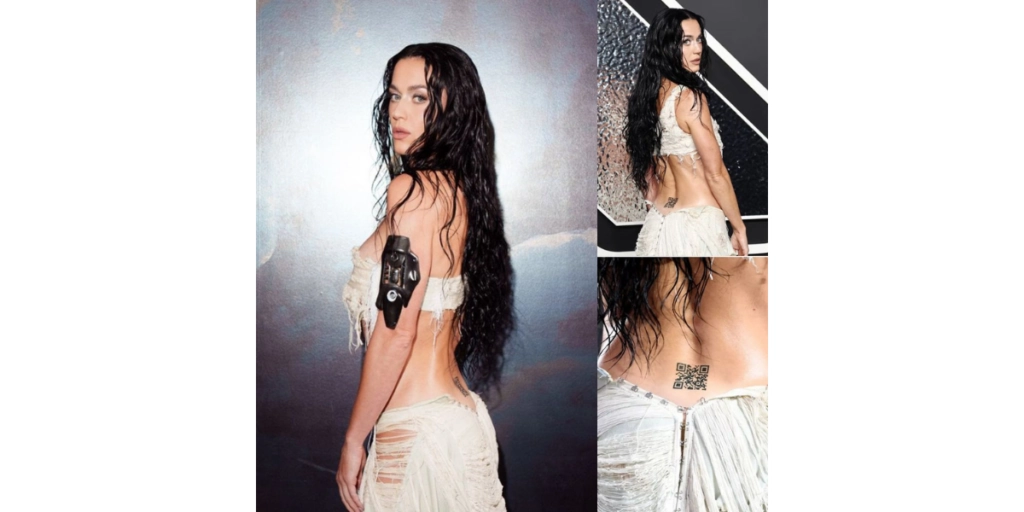 Back profile of Katy Perry at the VMAs, showcasing her lower back tattoo that links to her upcoming album.