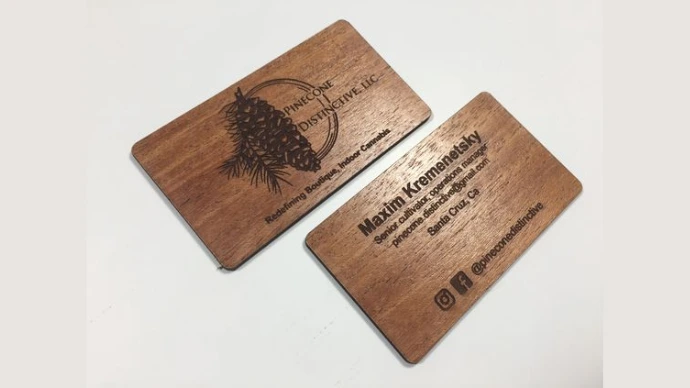 Two brown eco friendly wooden business cards