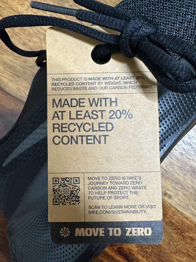 Small transparent QR Code with the logo on the Nike Shoe tag. Creating awareness of the brand's focus on sustainability.