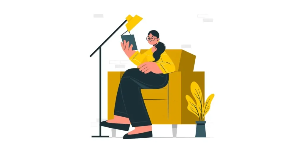 a woman reading a book on a chair