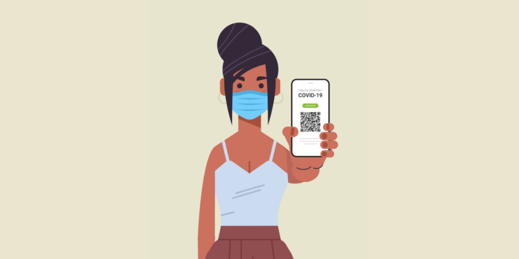 A woman wearing a face mask holding a smart phone with a QR Code on it