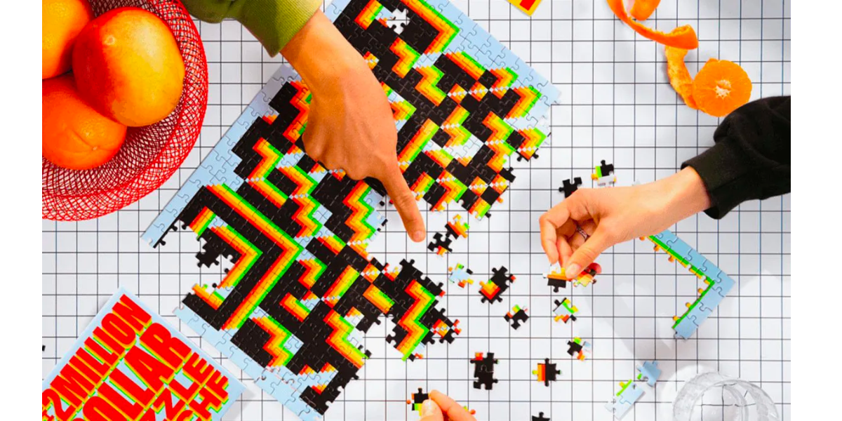 A group of people playing a jigsaw puzzle game that turns into a QR Code once completed, on a table