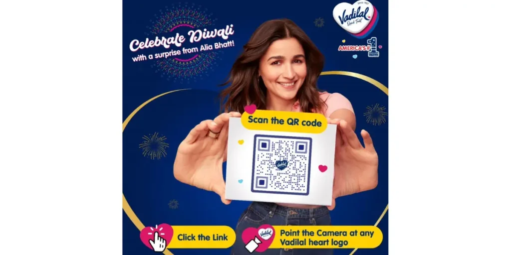 Vadilal Diwali promotional campaign where famous Indian celebrity Alia Bhatt is showing a box with a text - Scan the QR Code with a brief description of the next action items. 