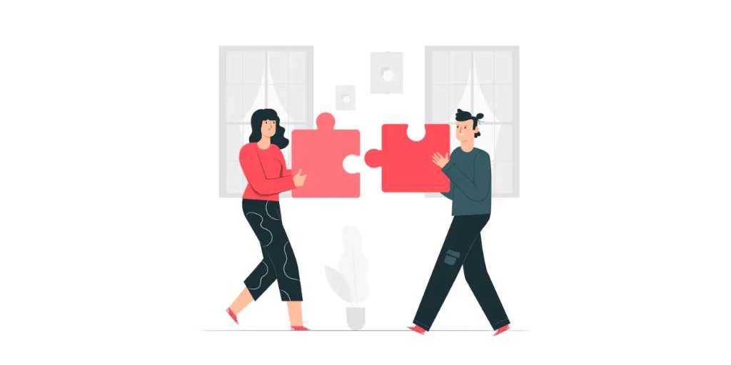 two people joining a jigsaw puzzle piece