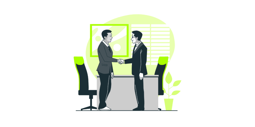 Two people shaking hands in an office set-up.