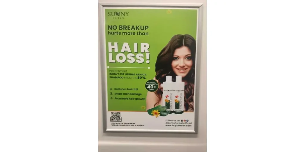 Sunny Herbals print ad for shampoo inside a metro featuring a QR code to visit their website.