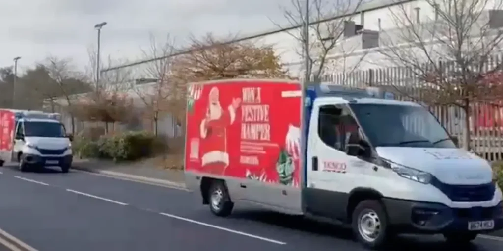 A Coca-Cola delivery van with Christmas wrapping and a QR Code inviting customers to explore and buy a special Christmas hamper.