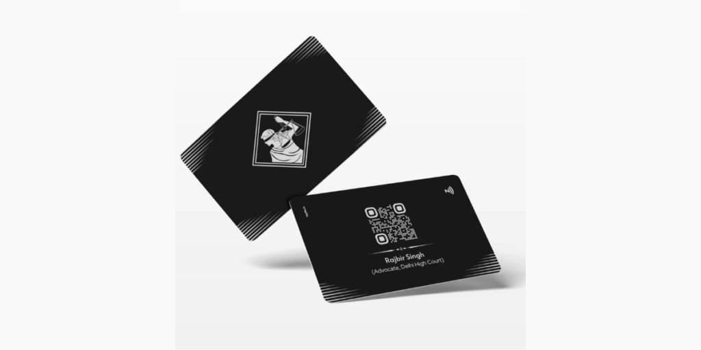 Metal business cards by Tapmo, bearing a balance lady logo.