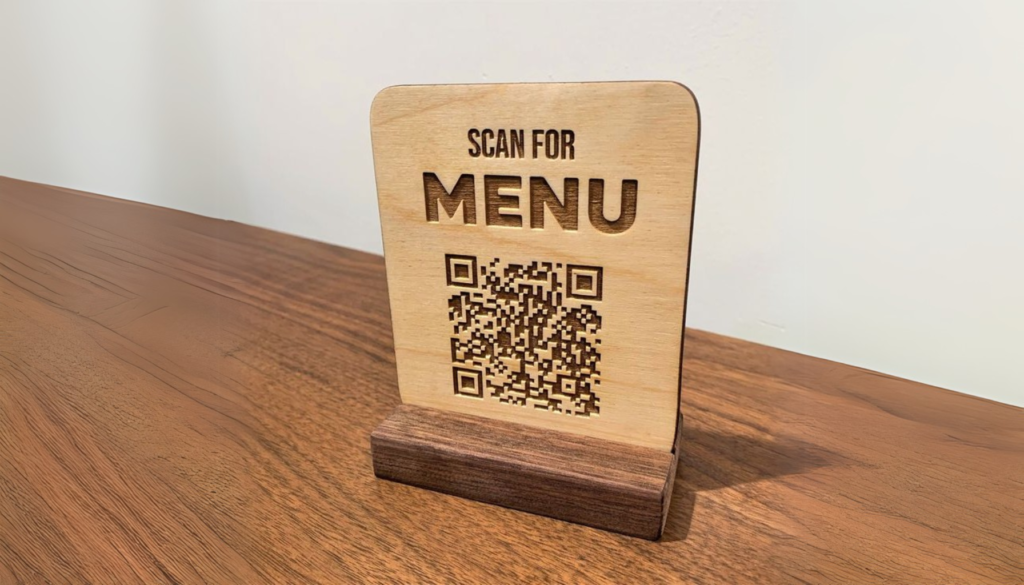 A laser cut QR Code engraved on an eco friendly material (wood).