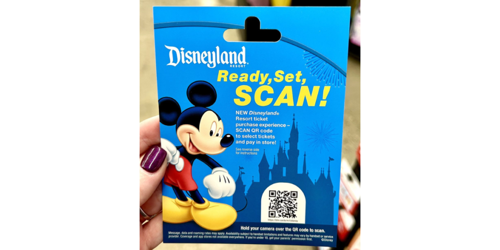 A woman holding a Disneyland QR Code.