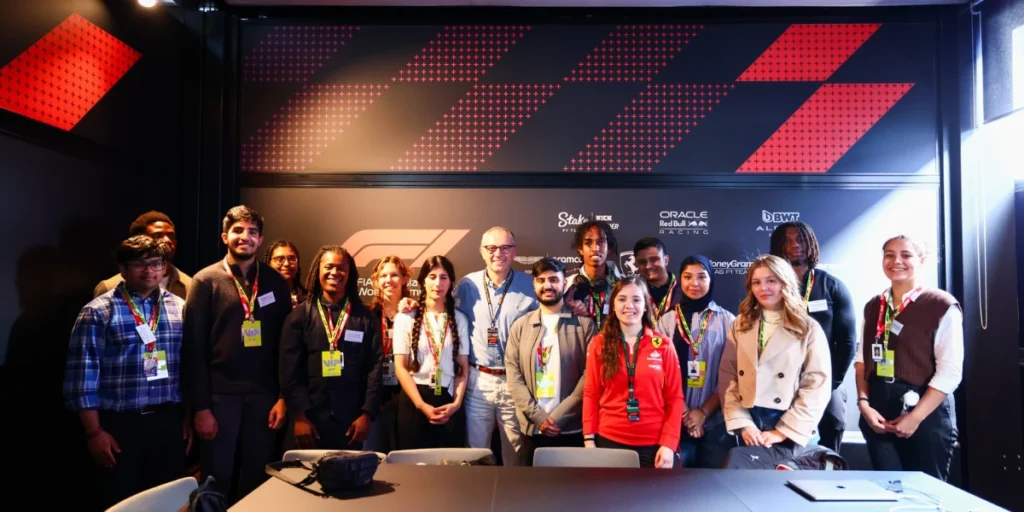 The staff member posing for a photo at F1 virtual flood relief event.