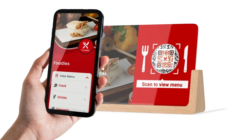 Hand-holding a smartphone, scanning a QR code in a restaurant with the text 'scan to view menu' for safe, contactless access.
